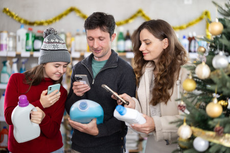 Family checking expiration date of detergent using smartphone