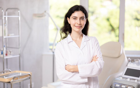 Middle aged woman doctor stands in hospital office, medical center. Modern medical care, tests, consultationの写真素材