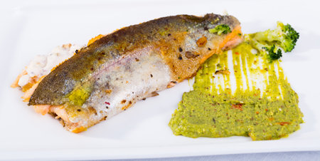 Tasty steak of fried river trout fillet with sause tartar on plateの写真素材