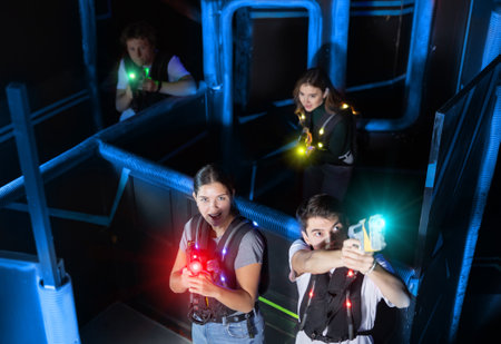 Team of young people play laser tag in labyrinth. View from aboveの写真素材