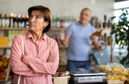 Senior husband stands behind pensioner wifeの写真素材