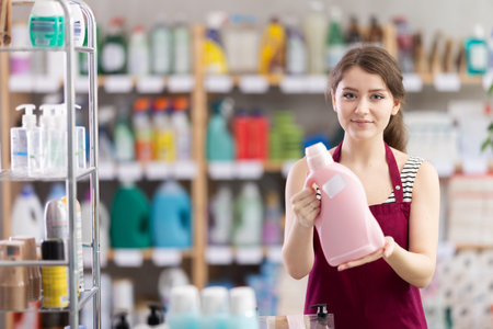 Young woman seller offering laundry detergentの写真素材
