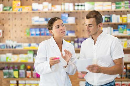 Man client with prescription should contact girl pharmacist for help, takes box remedyの写真素材