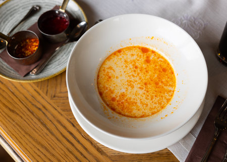 Small portion of traditional Bulgarian first course, shkembe chorba, is served in deep plateの写真素材