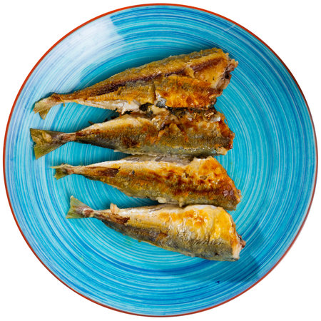 Fried carcasses of oceanic mackerel fish are laid out on plateの写真素材