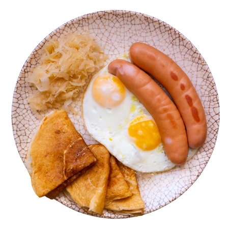 Fried sausages with scrambled eggs, pancakes and cabbageの写真素材