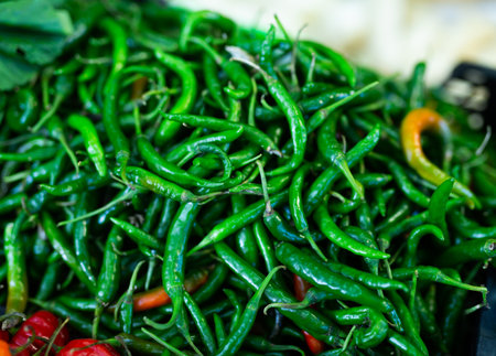 Fresh green anaheim peppers on counter market. Organic vegetable