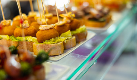 Pincho con croquetas - traditional Spanish snack or bar snack. Ham croquette and piece of baguetteの写真素材
