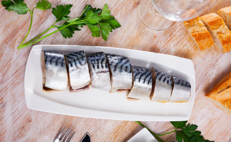 Closeup slices of slightly salted herring with parsleyの写真素材