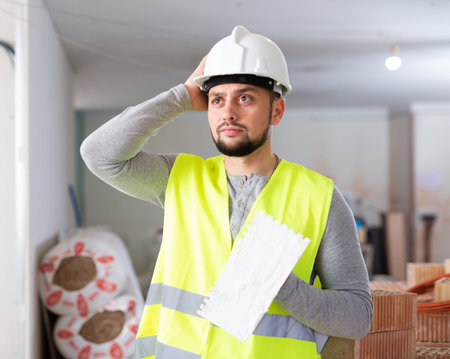Portrait of a builder in the process of working on a construction siteの写真素材