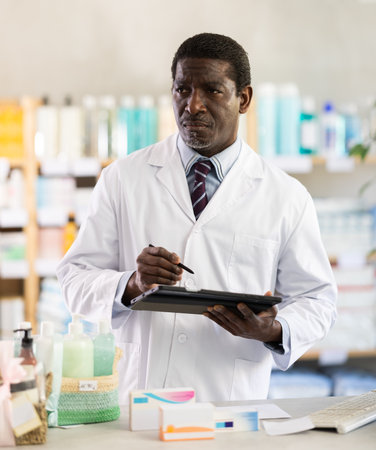 African man pharmacist makes restockの写真素材