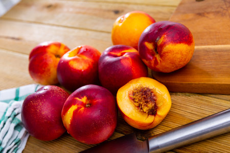 Ripe fresh organic nectarines on wooden background, vegan foodの写真素材
