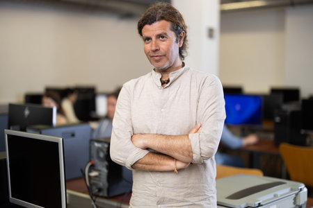 Portrait of a computer science teacher in university computer classroom