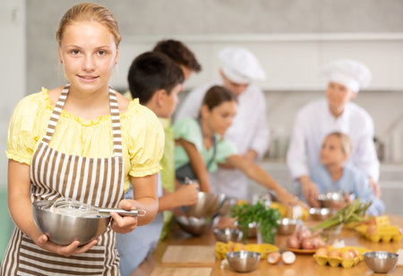 Teenage girl learns to cook at master classの写真素材