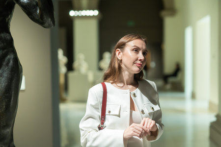 Girl view sculpture in museum hallの写真素材