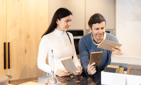 Couple chooses together the material from which they will order furniture and kitchen setの写真素材