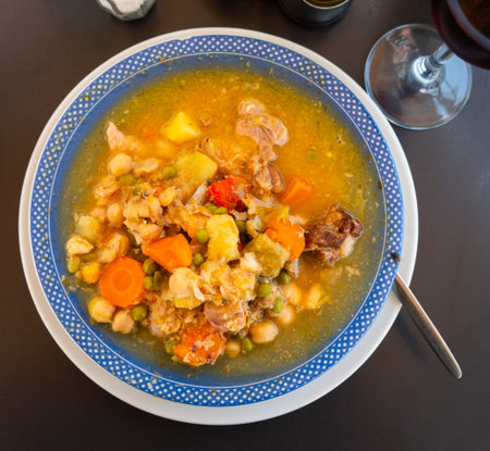 Plate with portion of hot chickpea and meat soupの写真素材