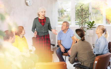 Elderly woman talks about her problems in group therapyの写真素材