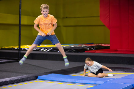 Playful boy jumping on trampoline at playground