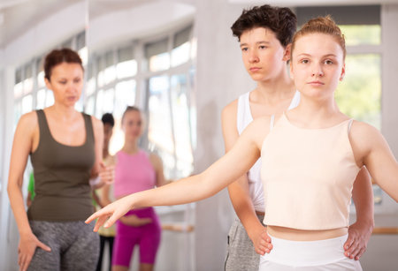 Teenage girl and boy training in pair in ballet studio
