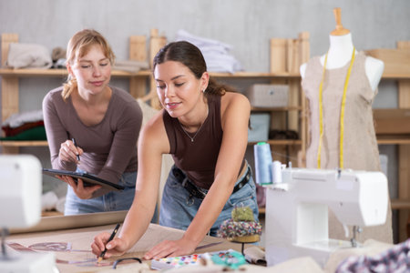 Two Female Tailors Drawing on Paperの写真素材