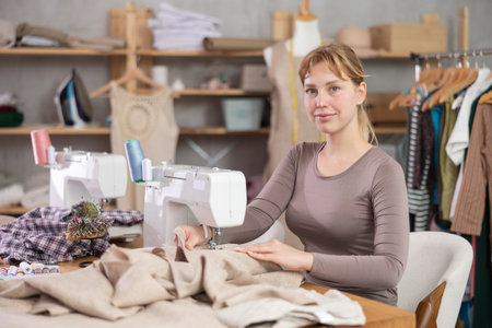 Woman tailor working at sewing machine