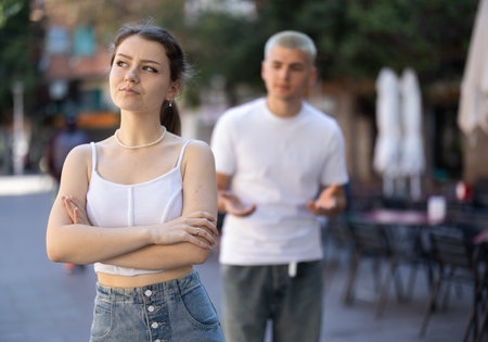Quarrel between guy and girl during walkの写真素材