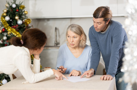 Man and woman help elderly mother make will and fill out document correctly On Christmas Eve