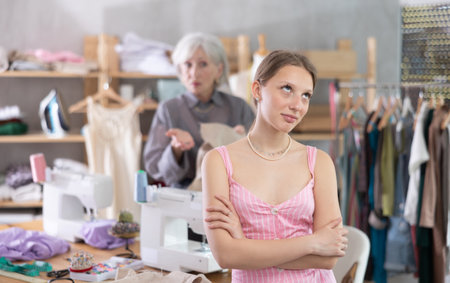 Mature dressmaker scolds assistant at workの写真素材