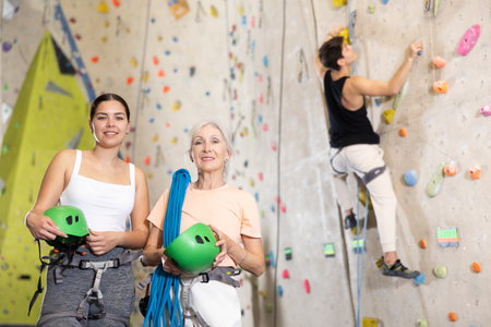 two active female participants are standing in climbing hallの写真素材