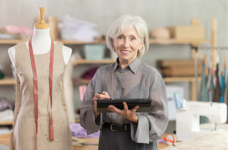 Woman dressmaker makes pattern using tablet