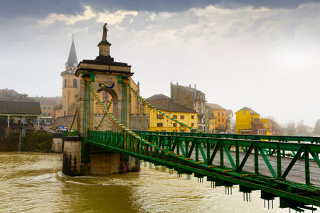 View of Seyssel on Rhone river with suspension bridge in winterの写真素材