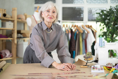 Mature fashion designer drawing on paperの写真素材