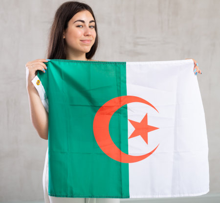 Young woman with flag posing in studioの写真素材