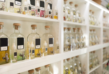 Bottles of perfume for sale on shelves of cosmetic shopの写真素材