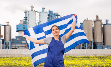 Cheerful young woman demonstrates the national flag of Greeceの写真素材