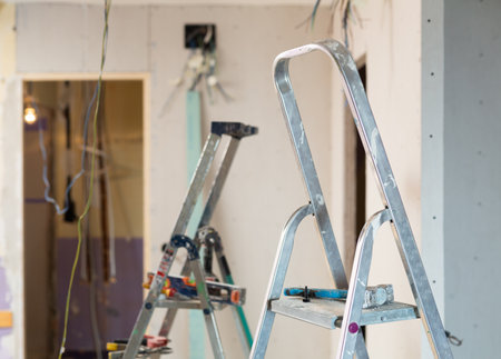 Stepladder in middle of a room under renovation in houseの写真素材
