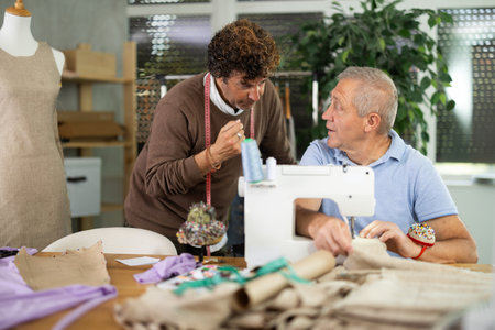 fashion designer sets tasks for the tailor to sew clothesの写真素材