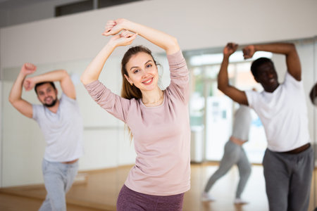 Young woman learning dynamic dances in choreography class