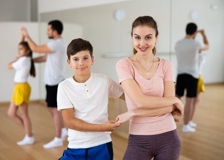Family practicing active dance in pairs