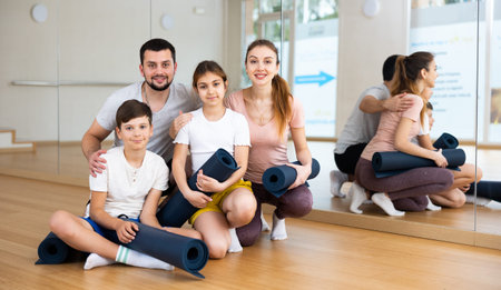 Portrait of happy family at yoga studio