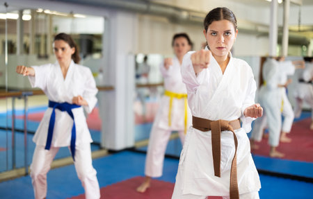 Female athletes standing in formation, kata starting position