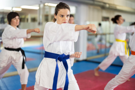 Women in self-defense training in white kimono with beltsの写真素材