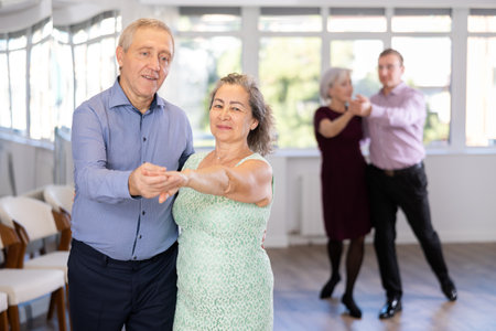Elderly man and elderly woman dance tangoの写真素材