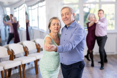 Elderly man and elderly woman dance tango