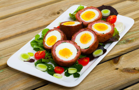 Scotch eggs with vegetable saladの写真素材