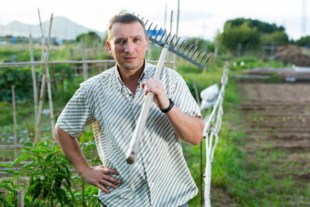 Amateur gardener posing in homestead garden during summer worksの写真素材