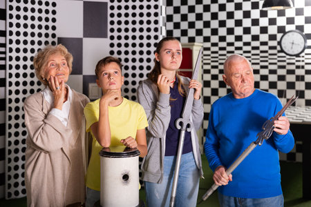Kids and grandparents thinking about conundrum solution in escape roomの写真素材