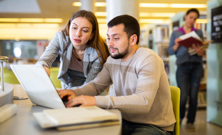 Couple of students spending time together in library