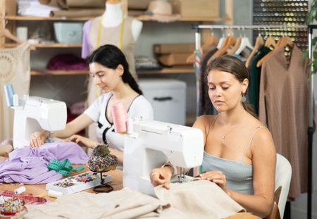 team of dressmakers sewing clothesの写真素材